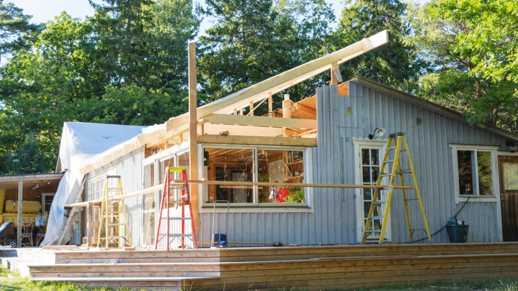 A home in Pinellas County undergoing disaster restoration and rebuilding, with new roof framing and supports being installed by a general contractor.